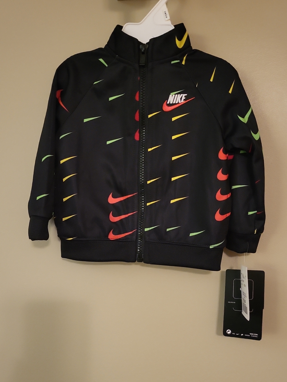 NWT Nike black athletic sweater with red, yellow & green swooshes